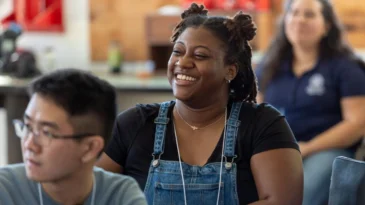 A young woman smiling in a classroom