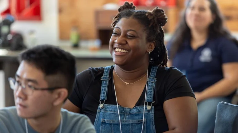 A young woman smiling in a classroom