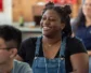 A young woman smiling in a classroom