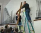 Church members at Christ Congregational Church remove the cross from the sanctuary to put in storage after selling their building. (Photo by Journey Films)