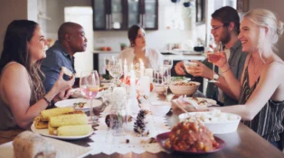 Shot of a group of young friends having a festive meal together at home