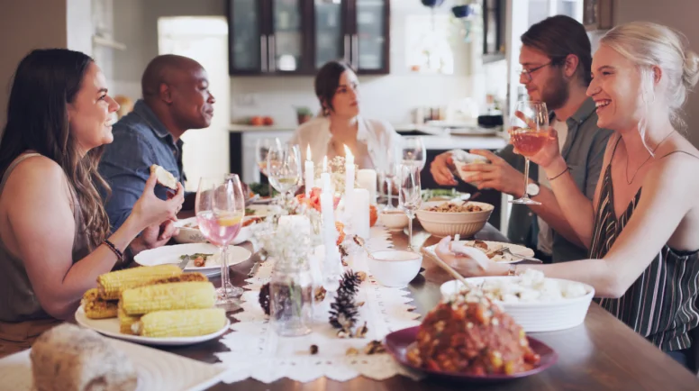 Shot of a group of young friends having a festive meal together at home