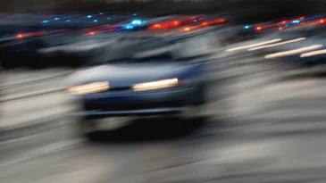 Traffic of cars on the night road with headlights.